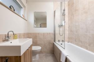 a bathroom with a sink and a toilet and a shower at East Vows - Elie in Earlsferry +32 photos