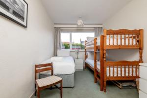 a bedroom with two bunk beds and a ladder at East Vows - Elie in Earlsferry