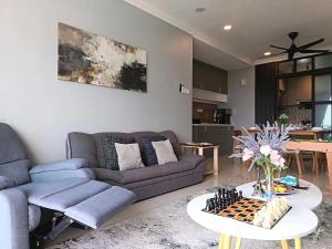 a living room with a couch and a table at Retro Game - D'Lagoon Sri Austin By iH Home in Kempas