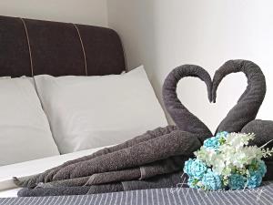 two swans made out of towels on a bed at Retro Game - D'Lagoon Sri Austin By iH Home in Kempas +35 photos