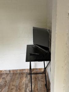 a black table with a laptop computer on it at balcon birds ecopolis in El Queremal