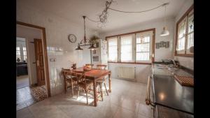 a kitchen with a table and chairs in a room at Maria La Franca in La Franca +17 photos
