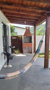 a hammock in a patio with a grill at Moradas Jane in Paulo Lopes