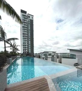 a large swimming pool on the roof of a building at Retro Game - D'Lagoon Sri Austin By iH Home in Kempas
