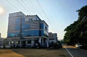 a building on the side of a street with a car at Crestview Inn in Lucknow