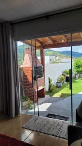 a sliding glass door with a view of a house at Moradas Jane in Paulo Lopes