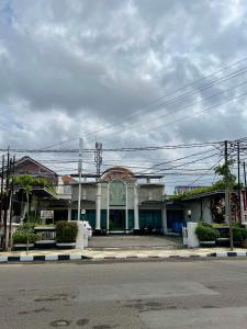 a building on the side of a street at Aurora Hotel Kartini in Cirebon