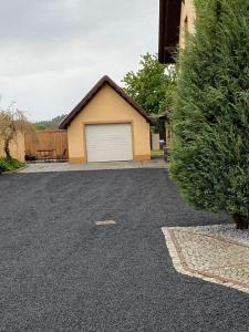 a driveway with a garage in front of a house at Mirenka in Czerna