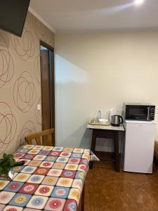 a room with a bed and a table and a refrigerator at Mirenka in Czerna