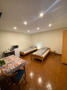 a room with two beds and a table at Mirenka in Czerna