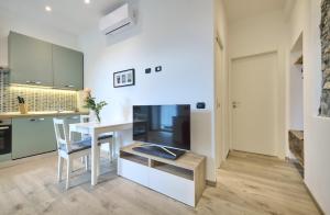 a kitchen with a table and a dining room at La cà del Pin in Lierna