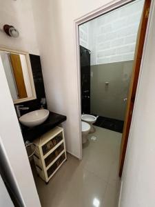 a bathroom with a sink and a toilet at Viva apart in Fiambalá