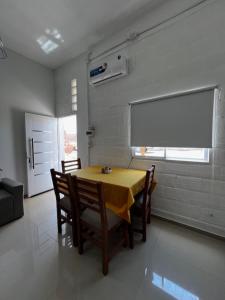 a dining room with a table and chairs and a window at Viva apart in Fiambalá