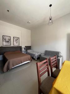 a bedroom with a bed and a table and chairs at Viva apart in Fiambalá