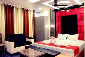 a hotel room with two beds and a chair at Golden View Hotel in Port Blair +27 photos