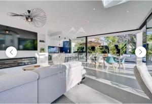 a living room with white furniture and a large window at SUPERBE Villa PISCINE moderne - Cap brun - plage de Toulon in Toulon