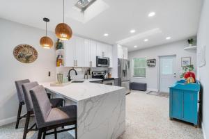 a kitchen with a counter and chairs in a room at Shady Banks Oasis in Fort Lauderdale