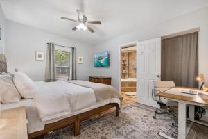 a bedroom with a bed and a desk and a window at Shady Banks Oasis in Fort Lauderdale