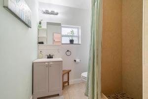 a bathroom with a sink and a toilet and a shower at Shady Banks Oasis in Fort Lauderdale +39 photos