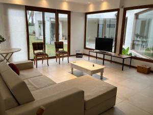 a living room with a couch and a tv at Casa Clara in Rufino