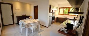 a kitchen with a table and chairs in a kitchen at Casa Clara in Rufino