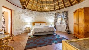 a bedroom with a bed and a table and chairs at Ramabanta Trading Post in Setleketseng