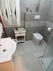 a bathroom with a toilet and a sink at Palazzo Carignano in Chioggia