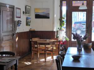 a dining room with a table and chairs at Auberge l'Escaleta in Seix +4 photos