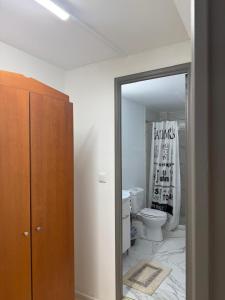 a bathroom with a toilet and a mirror at Escape at Chalandri Athens in Athens +43 photos
