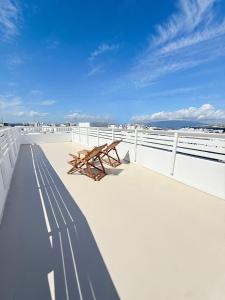 a wooden bench sitting on the deck of a boat at Dival Properties Mykonos 1 & 2 in Megali Ammos