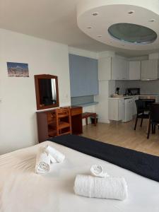 a bedroom with a bed with two towels on it at Escape at Chalandri Athens in Athens