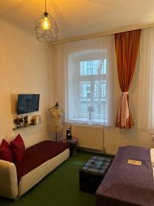 a bedroom with a bed and a window at Pension Stadthalle in Vienna
