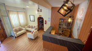 a living room with a couch and chairs in it at Apart Hotel de Alegria in Cusco