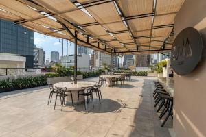 a patio with tables and chairs on a building at Cozy condo with rooftop in Roma Norte in Mexico City