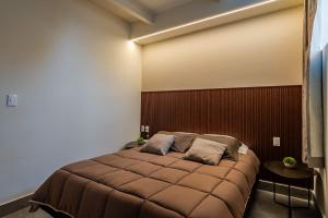a bedroom with a large bed with a brown headboard at Cozy condo with rooftop in Roma Norte in Mexico City