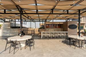 a restaurant with tables and chairs and a bar at Cozy condo with rooftop in Roma Norte in Mexico City
