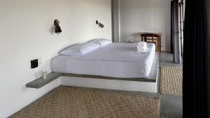 a bedroom with a large bed in a room at Soiree in Zipolite