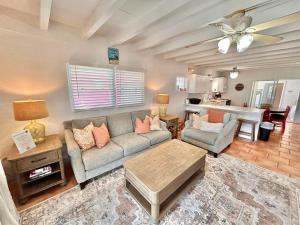 a living room with a couch and a table at Barefoot Beach Bungalow-Ground Level-3BR in St. George Island