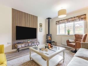 a living room with a large flat screen tv at 3 Bed in Penrith oc-86724 in Hackthorpe