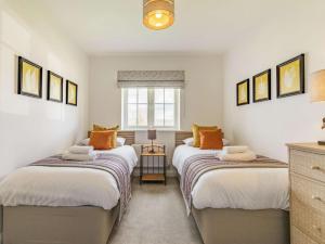 two beds in a room with white walls at 3 Bed in Penrith oc-86724 in Hackthorpe