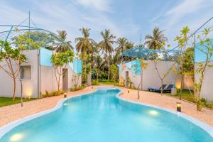 a swimming pool in the middle of a resort at Chaparrals Surf in Dickwella