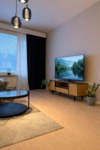 a living room with a flat screen tv on a wall at Tilava ja elegantti kolmio in Kokkola