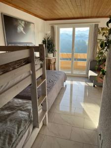 a bedroom with a bunk bed and a large window at Swiss Alps in Brenzikofen +32 photos
