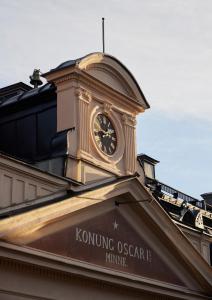 a clock on the top of a building at Stockholm Stadshotell in Stockholm