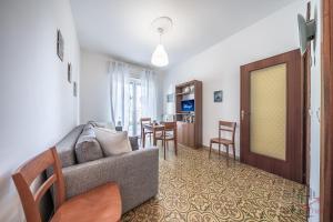 a living room with a couch and a table at Mare & Comfort - Box Auto - Balcone - Free Wifi in Borghetto Santo Spirito +19 photos