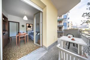 a balcony of a apartment with a table and a desk at Mare & Comfort - Box Auto - Balcone - Free Wifi in Borghetto Santo Spirito