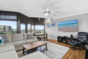 a living room with a couch and a tv at Marker 33 #2D3 in New Smyrna Beach