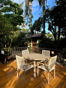 a table and chairs on a wooden deck at Hotel Natur Campeche in Florianópolis