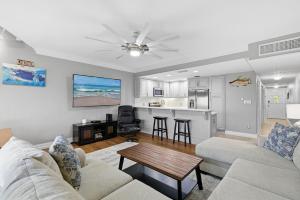 a living room with a couch and a table at Marker 33 #2D3 in New Smyrna Beach