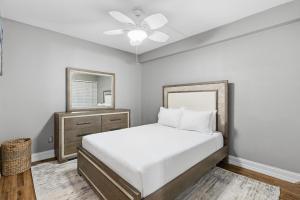 a bedroom with a bed and a mirror and a dresser at Marker 33 #2D3 in New Smyrna Beach +50 photos
